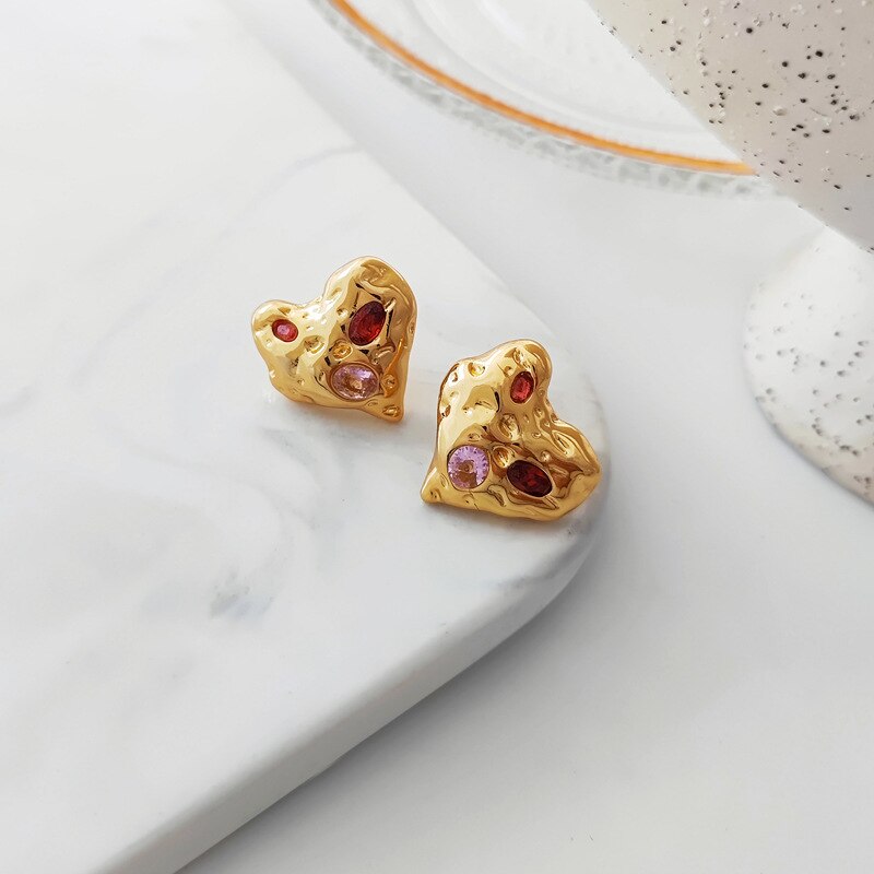 Golden Heart shaped earrings that look like stones with red and pink crystals 